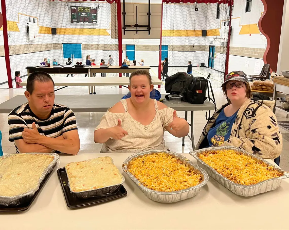 Harmony Centre participants proudly displaying meals they prepared during a cooking and life skills activity