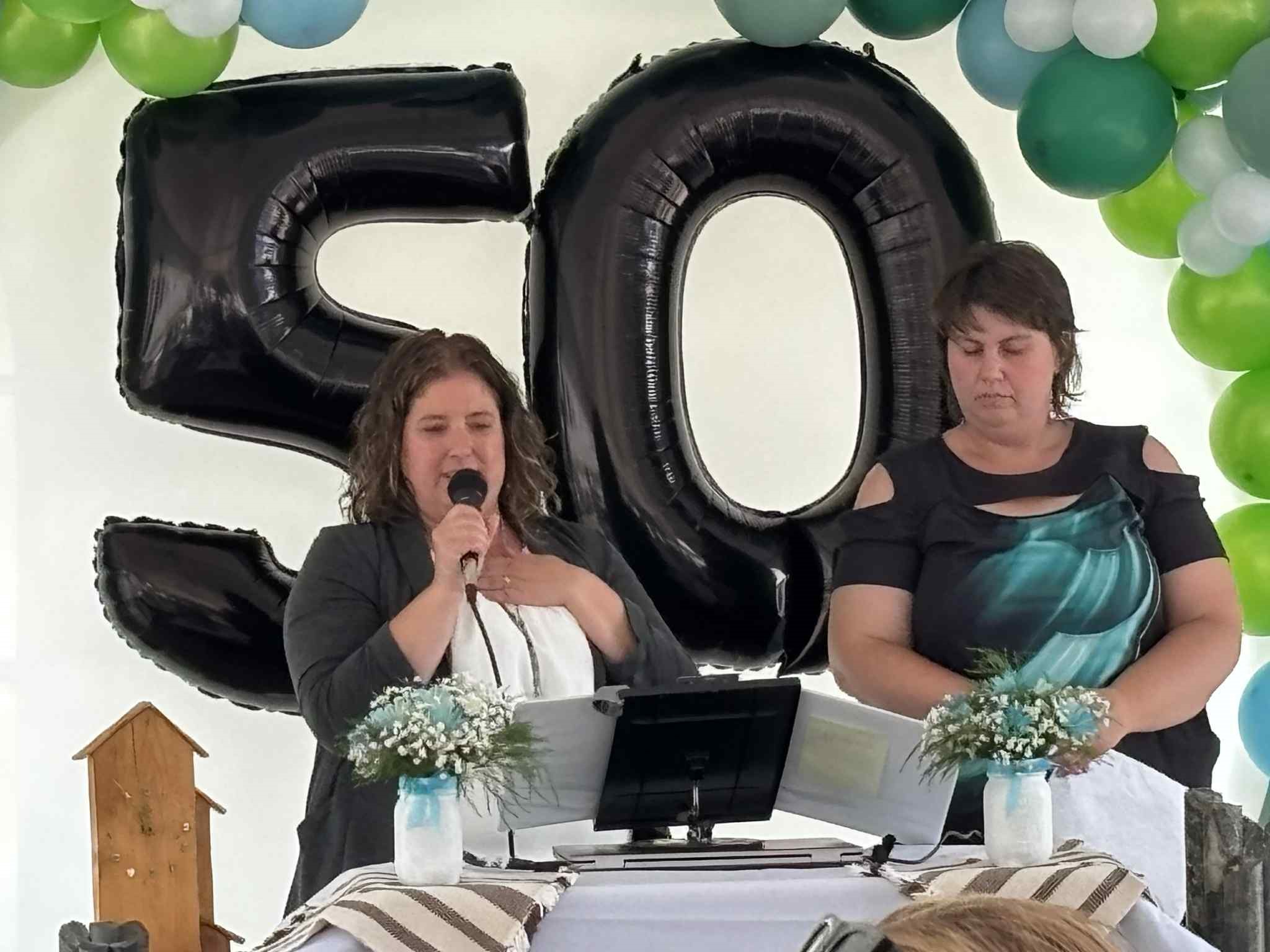 Harmony Centre leadership speaking at the 50th anniversary celebration