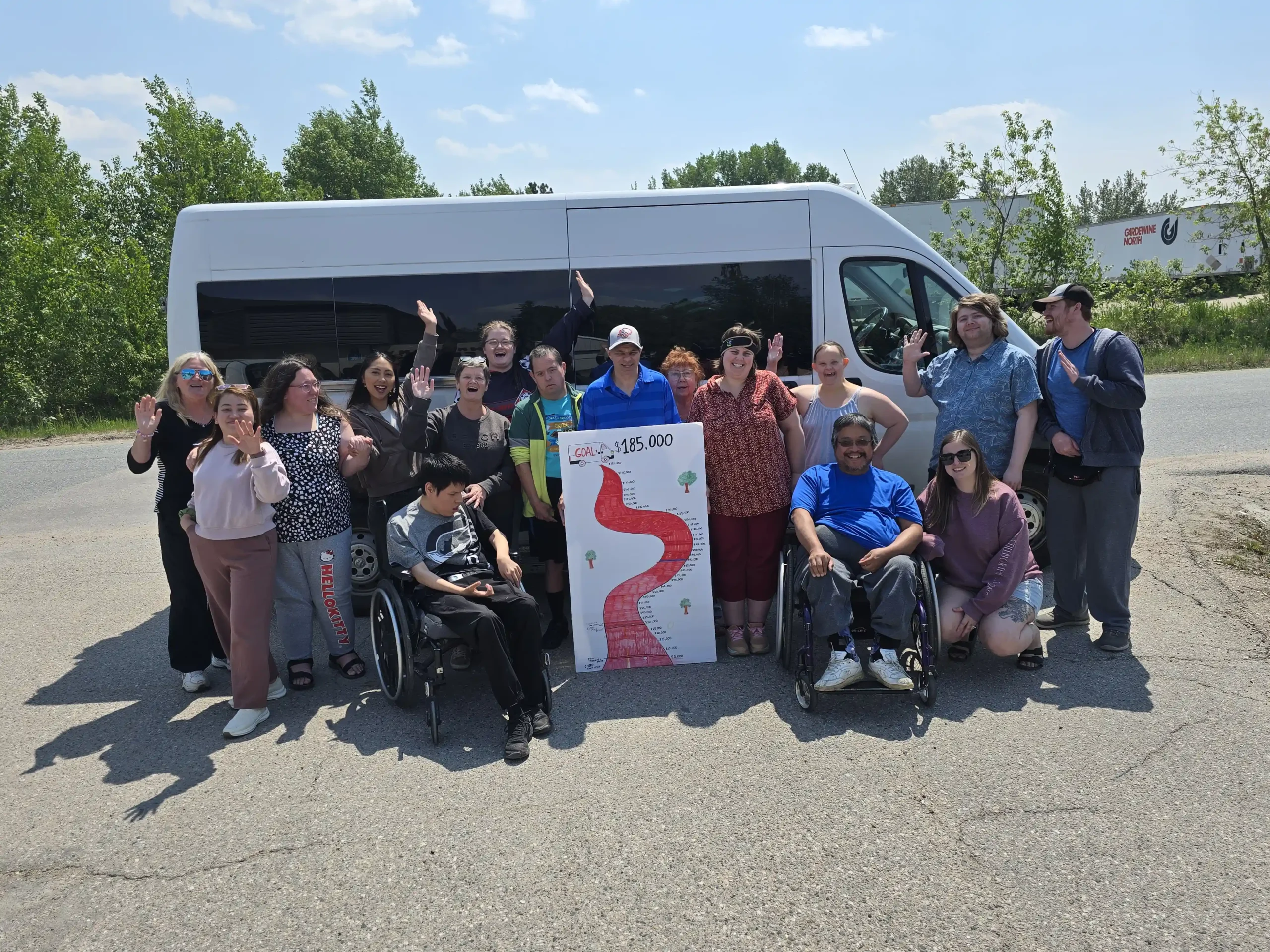 Harmony Centre participants and staff celebrating reaching their $185,000 bus fundraiser goal