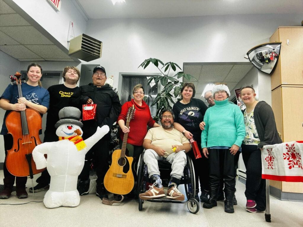 Harmony Centre participants and staff gathered for a holiday music celebration with instruments